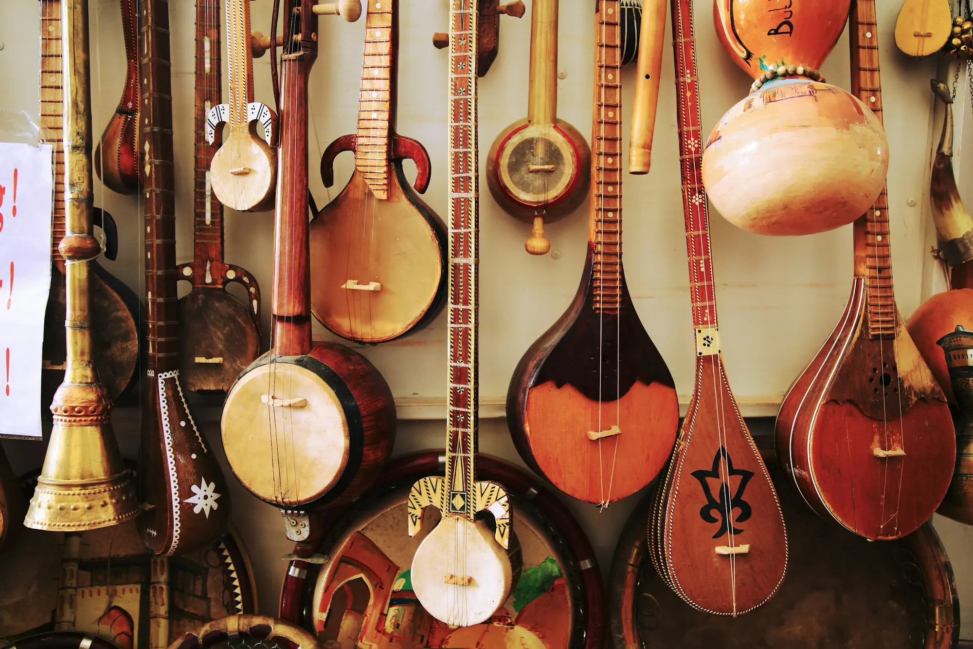 Mandolins, bouzoukis and other folk instruments hanging on a wall