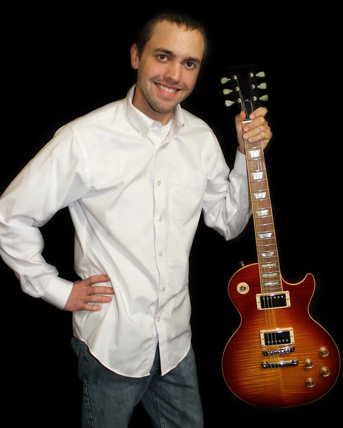 Luthier Wesley Wilkerson standing with a sunburst Les Paul–style guitar